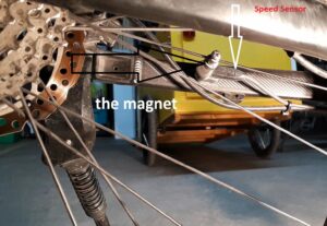 Turn the rear wheel until it reaches the spoke with the magnet